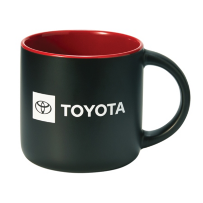 A black ceramic mug with a red interior. The mug features the Toyota logo and the word 'TOYOTA' printed in white on one side.