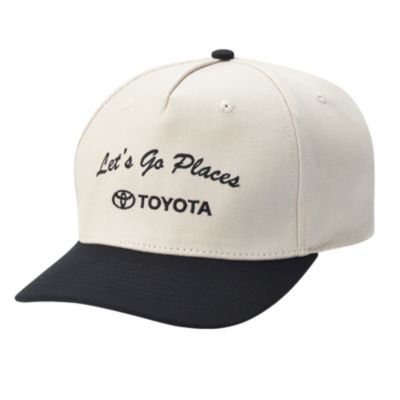 A beige baseball cap with a black brim. The front of the cap has the text 'Let's Go Places' embroidered in black, along with the Toyota logo and the word 'TOYOTA' beneath it