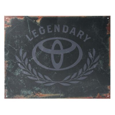 A weathered metal sign with a distressed black background features the Toyota logo in the center. Above the logo, the word 'LEGENDARY' is written in an arching style
