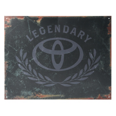 A weathered metal sign with a distressed black background features the Toyota logo in the center. Above the logo, the word 'LEGENDARY' is written in an arching style