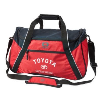 A red and black duffel bag with the Toyota logo and slogan 'Let's Go Places' printed on the front. The bag has a main zippered compartment, two handles, and an adjustable shoulder strap with padding