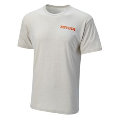 Oat colored tee with Toyota in italic front on left chest. Same font on back but going up the back in the middle. Text is printed in an orange fading color.