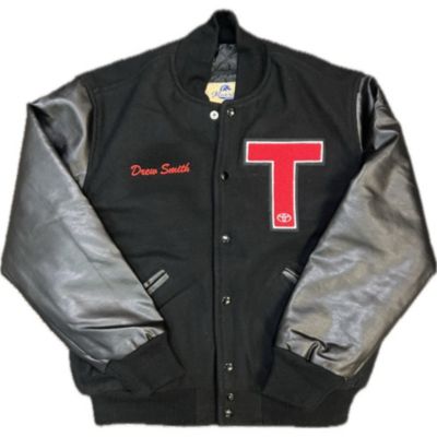 A black varsity jacket with leather sleeves, a red letter 'T' on the left chest