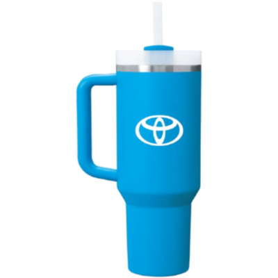 A blue travel mug with a handle and a straw lid, featuring the Toyota logo in white on its side