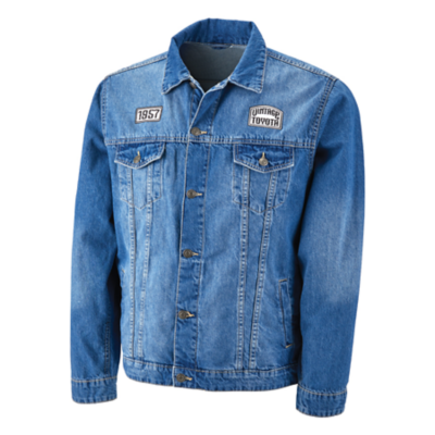 Blue denim jacket with two white and black woven patches on  chest. Left Chest has a vintage Toyota logo, right chest has the year 1957.