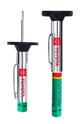 Toyota-branded tire tread depth gauges, one retracted and one extended to show a color-coded scale with green, yellow, and red sections indicating tread depth measurements