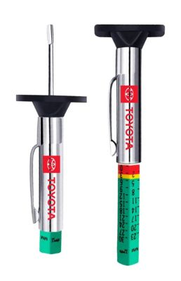 Toyota-branded tire tread depth gauges, one retracted and one extended to show a color-coded scale with green, yellow, and red sections indicating tread depth measurements