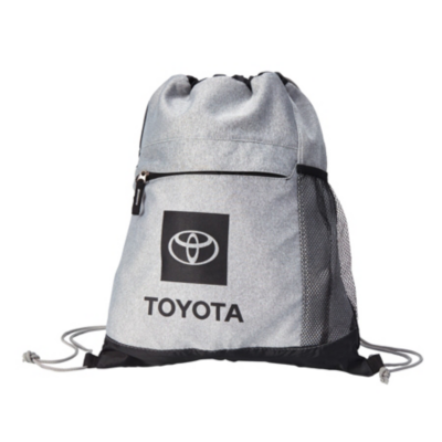 A gray drawstring backpack with a black front pocket featuring the Toyota logo and the word 'TOYOTA' printed below it. The backpack has black mesh side pockets and black drawstrings