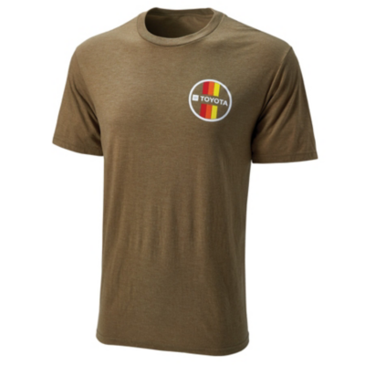 A brown short-sleeve T-shirt with a round neck. On the left chest area, there is a circular logo featuring vertical stripes in red, orange, and yellow colors with the word 'TOYOTA' in white text on a black background