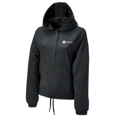 A black hooded jacket with a half-zip front, featuring the Toyota logo on the left chest. The jacket has long sleeves with elastic cuffs and a drawstring hem