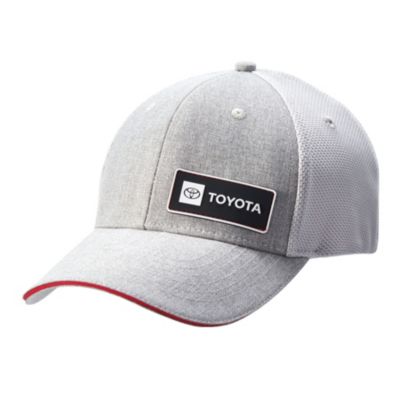 A light gray baseball cap with a black patch featuring the Toyota logo and TOYOTA. The cap has a red trim on the brim and a mesh back
