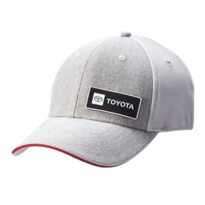A light gray baseball cap with a black patch featuring the Toyota logo and TOYOTA. The cap has a red trim on the brim and a mesh back
