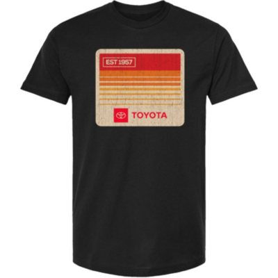 A black T-shirt with a retro design featuring orange and red stripes, EST 1957, TOYOTA, and the Toyota logo.