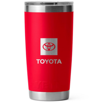 A red YETI tumbler with a stainless steel rim and base. The front of the tumbler features the Toyota bug and the word TOYOTA written below it both laser etched