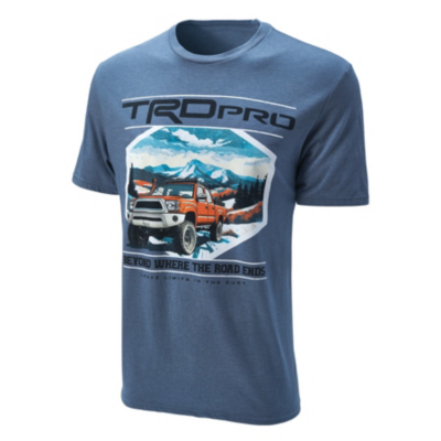 A blue T-shirt featuring a graphic design of an orange off-road vehicle driving through a mountainous landscape with pine trees. The text 'TRD Pro' is displayed prominently above the graphic.