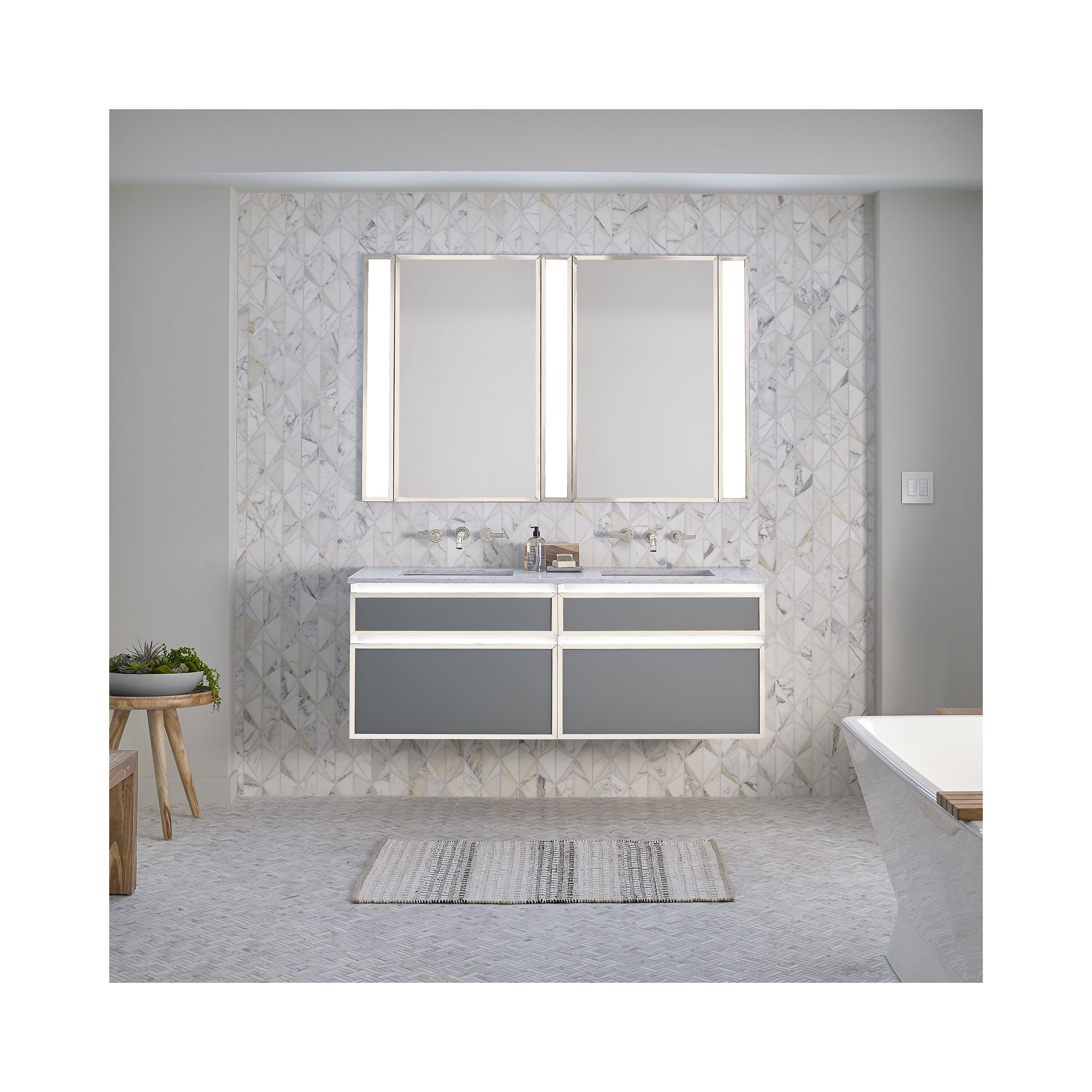 Vanity setup with grey and white marble in a bathroom.
