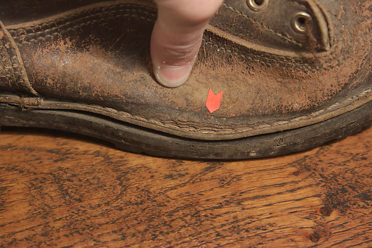 boot with cracked leather at welt base