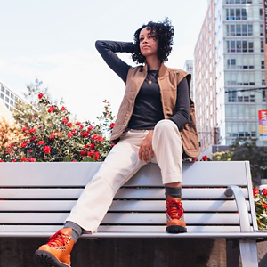 a pair of brown work boots with orange accents