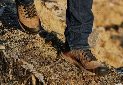 Lower body view of hiker walking on a rugged mountain trail