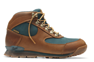 A brown leather boot shown in profile view with teal textile inlays and gold eyelets, there is some dirt showing on the outsole.