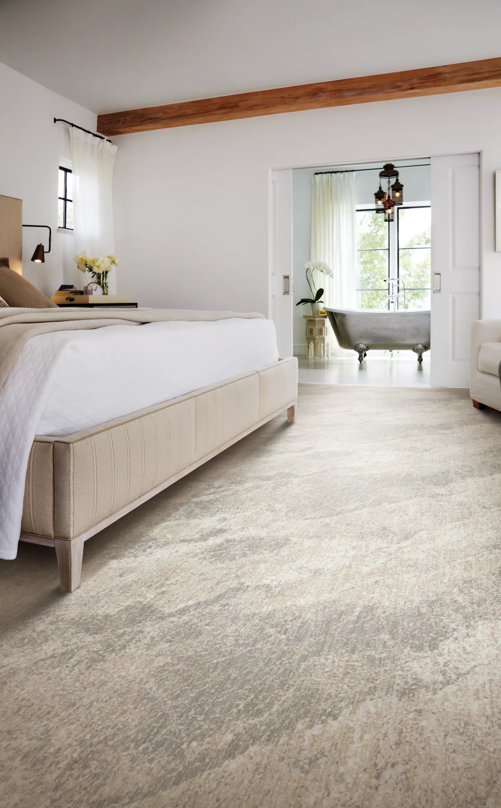 Soft neutral carpet beside an upholstered bed in a traditional cream bedroom