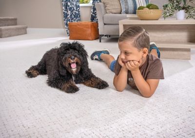 dog and boy laying on floor