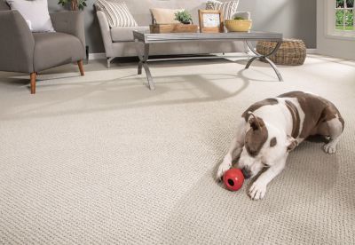 girl having a tea party with a toy rhino wearing a pearl necklace