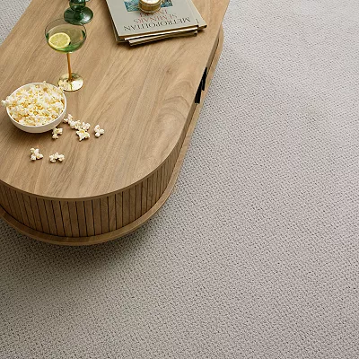 wooden coffee table on grey carpet flooring