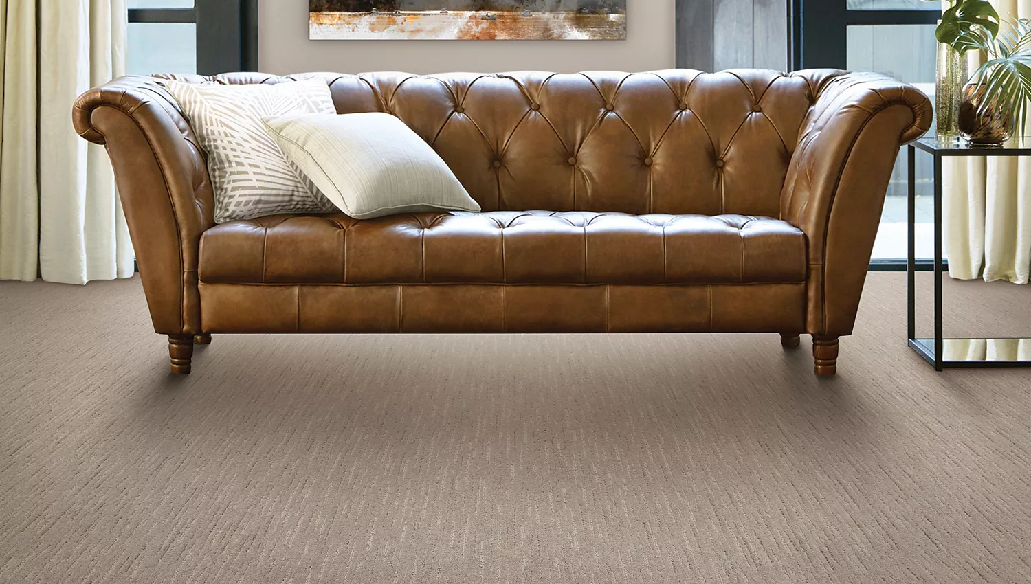 Tufted Leather couch on light grey carpet