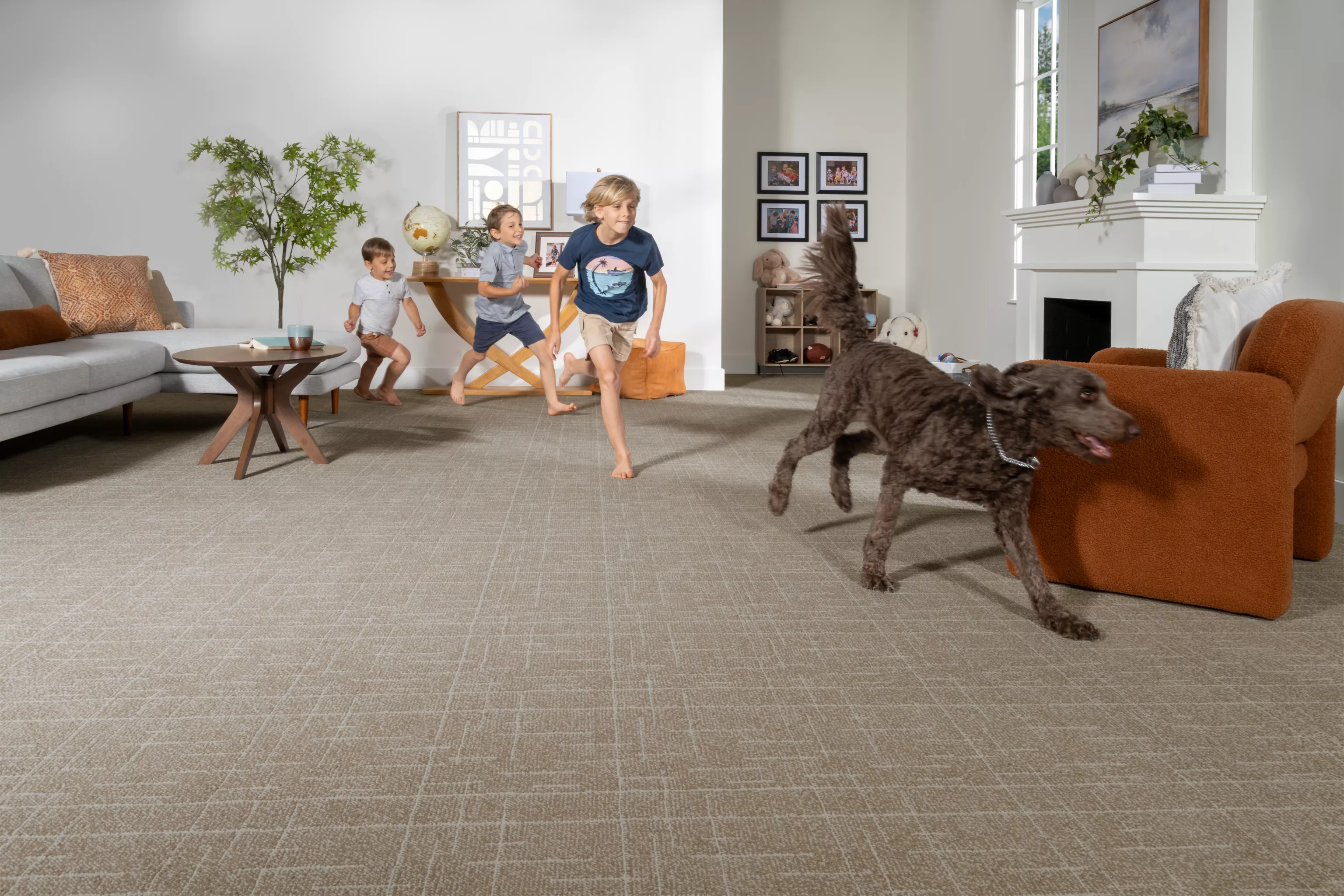 two girls petting a dog on light grey carpet