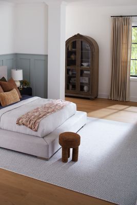 bedroom scene with a rug and hardwood floors