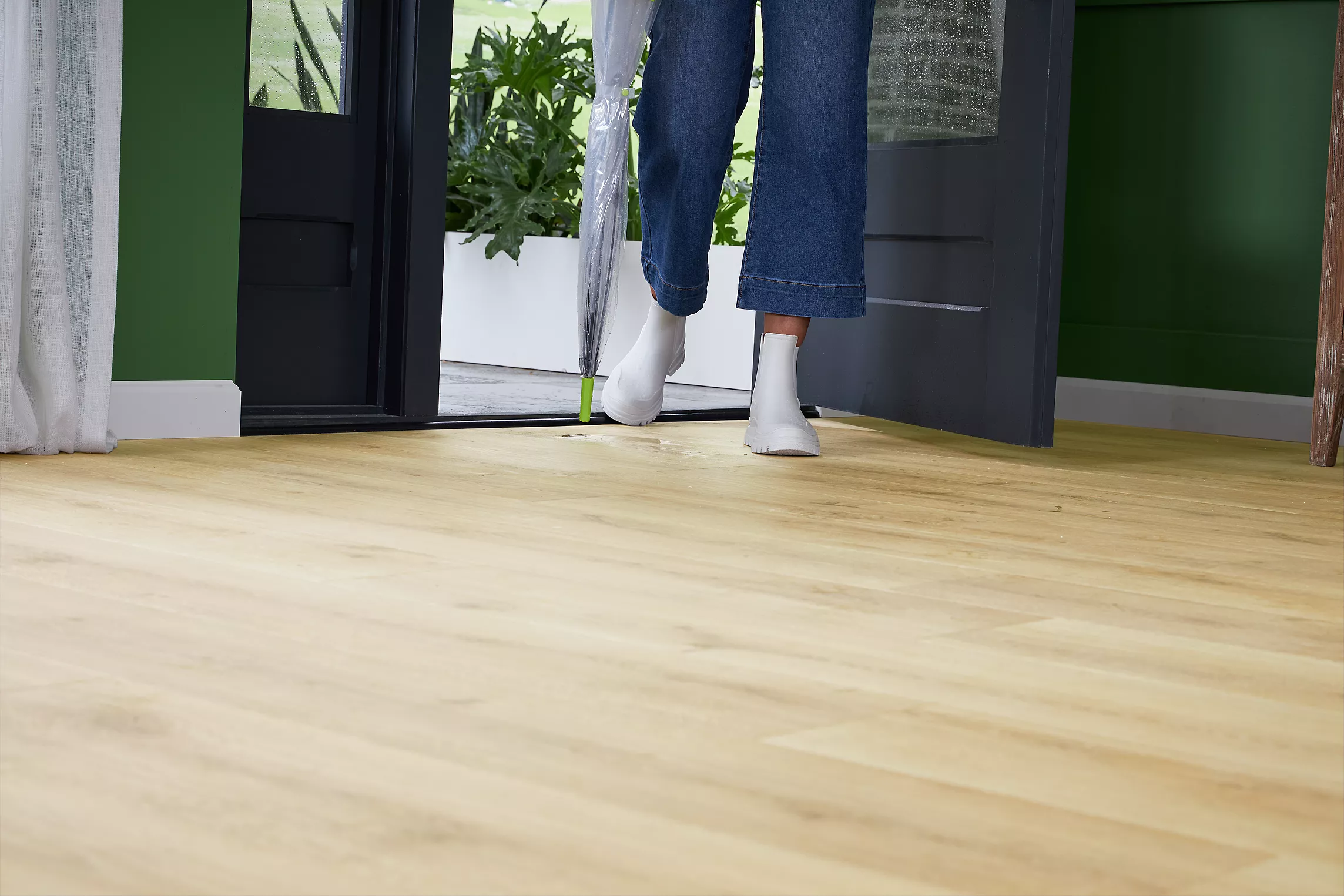 Set of feet walking on top of Karastan Belleluxe waterproof flooring