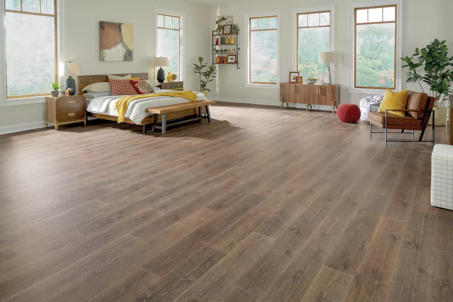 Brown flooring in a bedroom with a brown chair