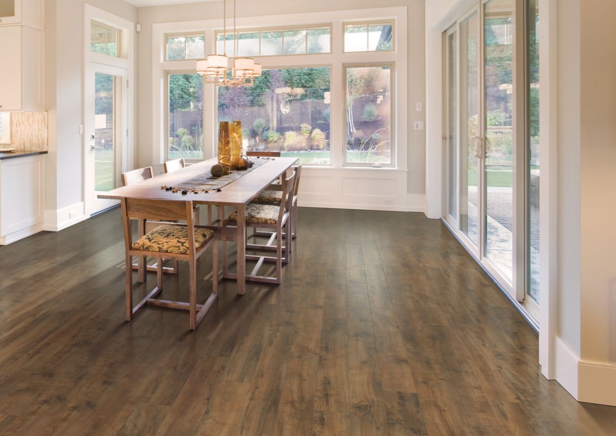 Warm brown laminate floors in spacious dining room