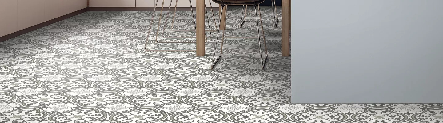 round intricate pattern of grey carpet