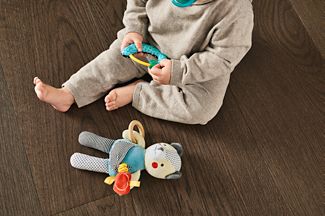 baby playing on hardwood floors