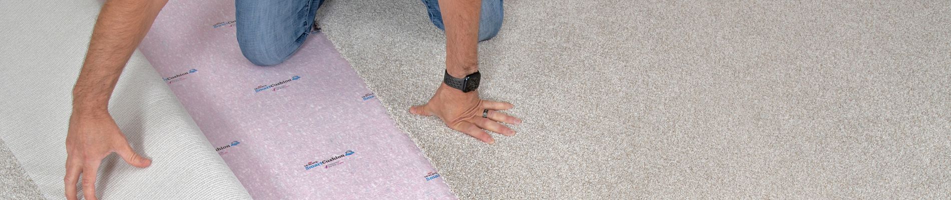 Worker installing carpet flooring