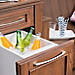 Keep beverages cool when entertaining guests with a pull out ice cooler from Trex's Outdoor Storage line 