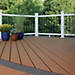 Trex decking in Classic white, Beach Dune, and Clam Shell work together to pull off this deck design's elegant look.