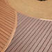 Closeup of Trex Transcend decking reveals curved lines using two different colors, Tiki Torch and Lava Rock.
