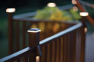Close up view of Trex Signature railing in Charcoal Black with a post cap light.