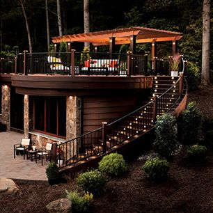 Trex Signature railing in Charcoal Black complements the vastness of a Transcend deck in Lava Rock and Tiki torch as shown in the Shenandoah Collection