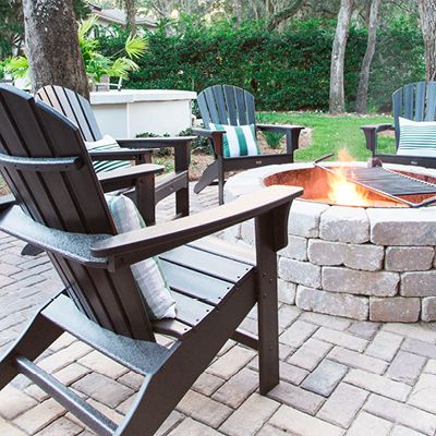 Thumbnail of Trex Cape Cod Adirondack Chairs circled around a fire.