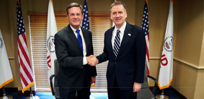 USAID Administrator Mark Green and Corteva Agriscience Chief Executive Officer-Elect Jim Collins shake hands after the signing